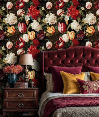 Dramatic floral wallpaper showing red and white blooms in opulent bedroom with burgundy tufted headboard
