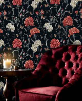 Dramatic floral wallpaper with coral and cream carnations in sophisticated living room with burgundy velvet chair
