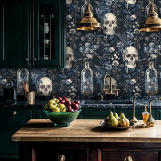 Dramatic gothic floral wallpaper with skulls, shown in modern kitchen with dark green cabinetry and brass fixtures