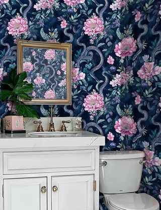 Dramatic serpent garden wallpaper with pink blooms, displayed in elegant powder room with marble vanity