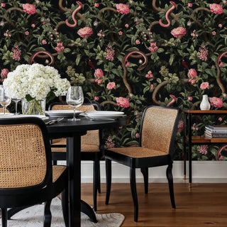 Dramatic serpentine botanical wallpaper with pink blooms, featured in sophisticated dining room with cane chairs