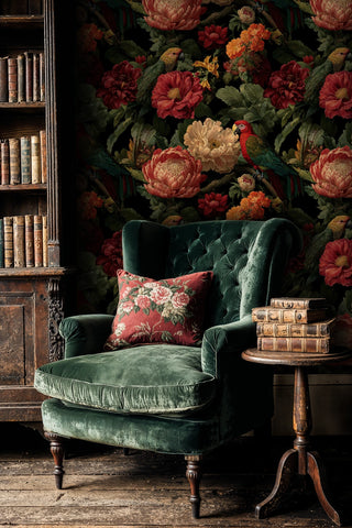 Dramatic tropical wallpaper with parrots and flowers, featured in classic library with green armchair