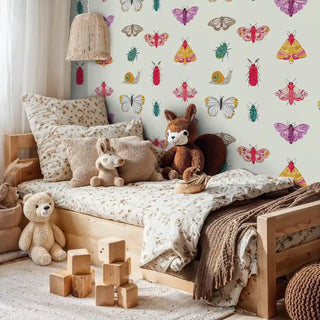 Educational insect wallpaper showing butterflies and beetles in cozy children's room with wooden bed frame