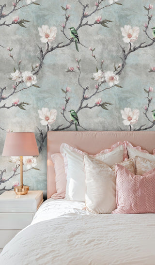 Elegant bird and flower wallpaper in soft bedroom with pink bedding and white nightstand