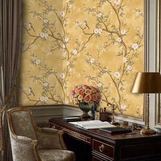 Elegant chinoiserie wallpaper with songbirds and flowering branches, shown in sophisticated home office with mahogany desk
