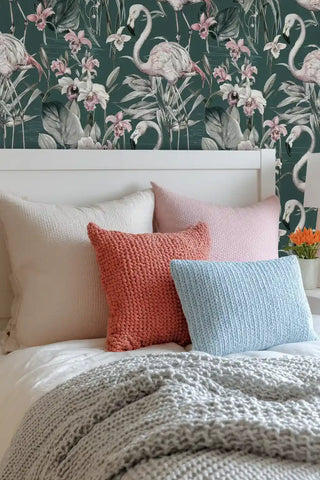 Elegant flamingo wallpaper with tropical flowers and emerald background styled behind white upholstered bed