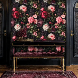 Elegant peony wallpaper with a dark background in a sophisticated entryway, featuring a velvet bench under a black console table.
