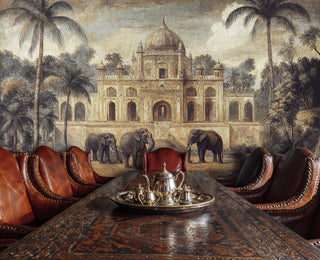 Elephant and palace wall mural in earthy beige and green hues, behind a dining table with silver tea set and leather chairs