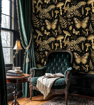Enchanted botanical wallpaper with gold accents on black, shown in traditional study with window seat