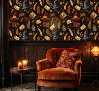 Enchanted elements wallpaper featuring wizard hats and quill feathers, shown in elegant study with orange velvet armchair