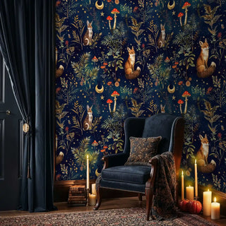 Enchanted forest wallpaper featuring woodland animals and golden stars, shown in cozy reading chair nook with candlelight