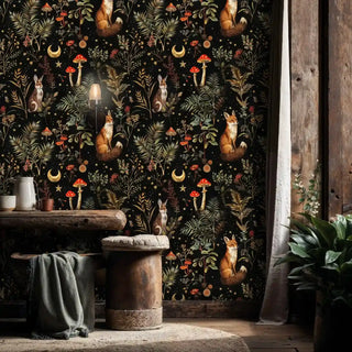 Enchanted forest wallpaper featuring woodland creatures and botanicals, displayed in rustic room with wooden stool