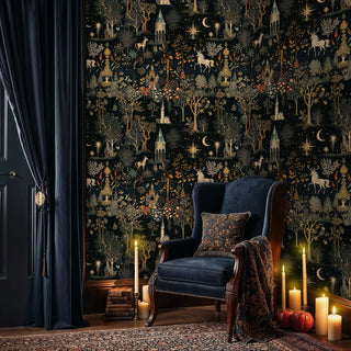 Enchanted forest wallpaper with castles, deer, and golden florals in cozy reading room with navy armchair