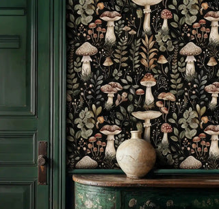 enchanted forest wallpaper with spotted mushrooms and botanical leaves on black, in rustic entryway with green cabinet