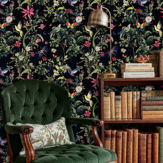 Enchanted garden wallpaper with hummingbirds and butterflies on dark background, in elegant study with green chair and bookshelf