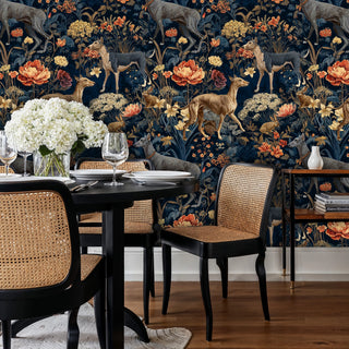 Enchanted woodland wallpaper featuring deer and florals, displayed in sophisticated study with leather armchair and books