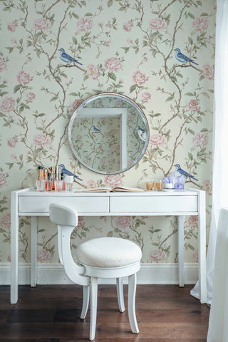 English rose wallpaper with bird motifs, soft pink and cream palette, shown in elegant bedroom with white vanity
