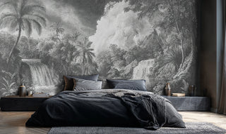 Engraved jungle wall mural featuring waterfalls and dense palms in charcoal, in a modern bedroom with dark bedding and stone nightstands