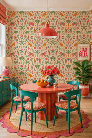 Exotic animal wallpaper with palms, birds and elephants, teal and coral tones, in a dining room with round table