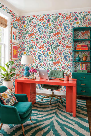 Exotic leopard and bird folk art wallpaper with colorful florals on white, in a bold home office with orange desk