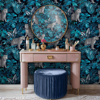 Exotic leopard wallpaper featuring wild cats in lush botanicals, displayed in elegant dressing room with pink vanity