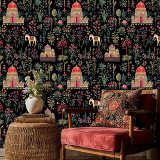 Exotic palace wallpaper with golden temples and botanical motifs shown in cozy reading nook with wicker table