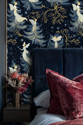 Fairy wallpaper with luminous figures, stars and gold branches in navy, styled with a navy headboard and pink flowers