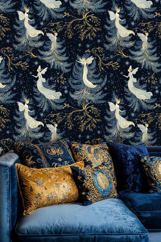 Fairy wallpaper with winged figures, starry details and gold branches in navy, above a blue sofa with patterned pillows