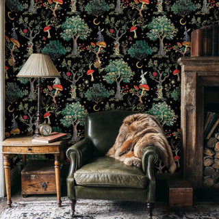 Fairytale forest wallpaper with red mushrooms and golden moons in a cozy study with leather chair and fur throw