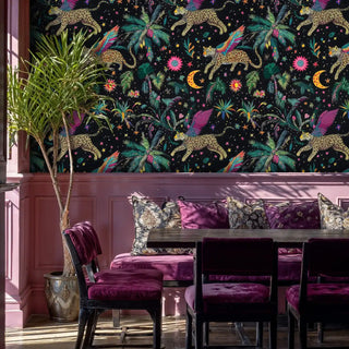 Fantasy tropical wallpaper featuring magical leopards and florals in dining room with burgundy velvet seating