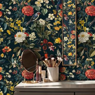 Floral bird wallpaper with coral peonies and yellow flowers, styled in bathroom with gold mirror and brushes