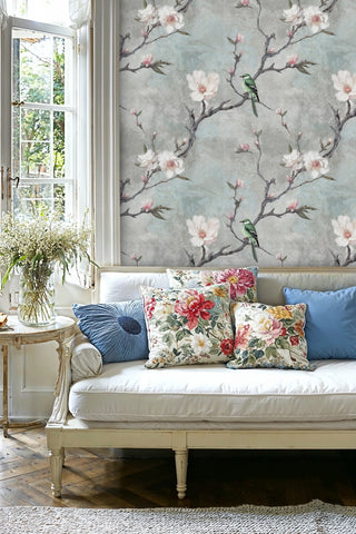 Floral bird wallpaper with magnolia blooms displayed in bright living room with french doors