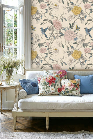 Floral bird wallpaper with trailing vines and blooms, in a bright living room with white settee