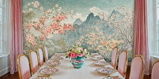 Floral landscape wall mural with cherry blossoms in formal dining room with gold-framed chairs and marble table