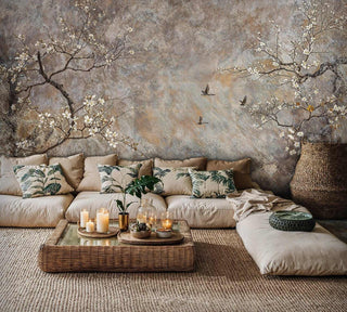 Floral wall mural with cherry branches and flying birds in modern living room with sectional sofa and rattan coffee table