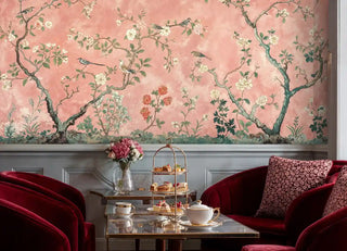 Flowering tree wall mural featuring songbirds shown in sophisticated lounge with velvet armchairs