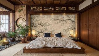 Flowering tree wall mural in neutral tones behind a low platform bed in a Japanese-style bedroom with paper lanterns