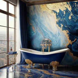 Fluid blue and gold marble wall mural with luminous swirls behind a freestanding clawfoot bathtub in luxury bathroom