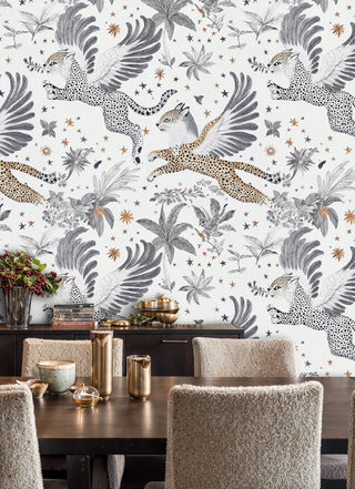 Flying leopard wallpaper with celestial stars and foliage in a dining room with brass vessels and boucle chairs