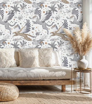 Flying leopard wallpaper with palm motifs in a boho lounge with linen daybed and pampas grass
