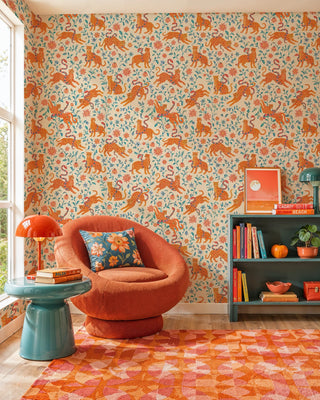 Folk leopard wallpaper with coral florals and teal foliage, in a reading nook with round swivel armchair