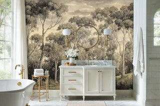 Forest landscape wall mural featuring eucalyptus trees in bathroom with white vanity and gold mirror