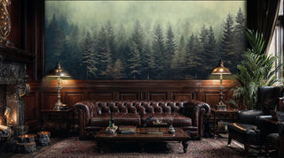 Forest landscape wallpaper with misty conifers displayed in an elegant study with chesterfield sofa and brass lamps