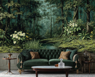 Forest mural with towering trees and a tranquil stream behind a tufted emerald Chesterfield sofa and crystal decanter