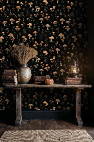 Forest mushroom wallpaper with amber fungi and ferns on dark background, displayed in rustic study with ceramic vase