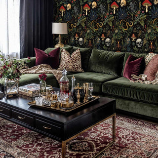 forest skull wallpaper with botanical elements in luxurious living room with green velvet sofa
