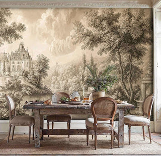 French chateau landscape wall mural with castle, trees, and classical architecture, shown in dining room with cane chairs