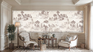 French toile wall mural with pastoral scenes in sepia on ivory, in a classic sitting room with armchairs and floor lamp