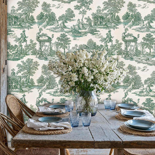 French toile wallpaper featuring pastoral scenes, displayed in rustic dining room with wooden table