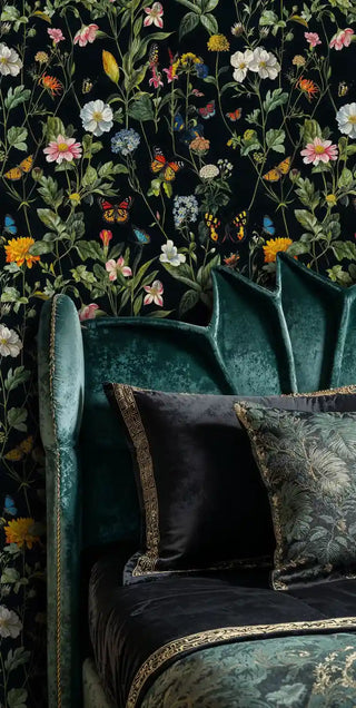Garden butterfly wallpaper with vibrant wildflowers on black, in luxurious sitting room with emerald velvet armchair